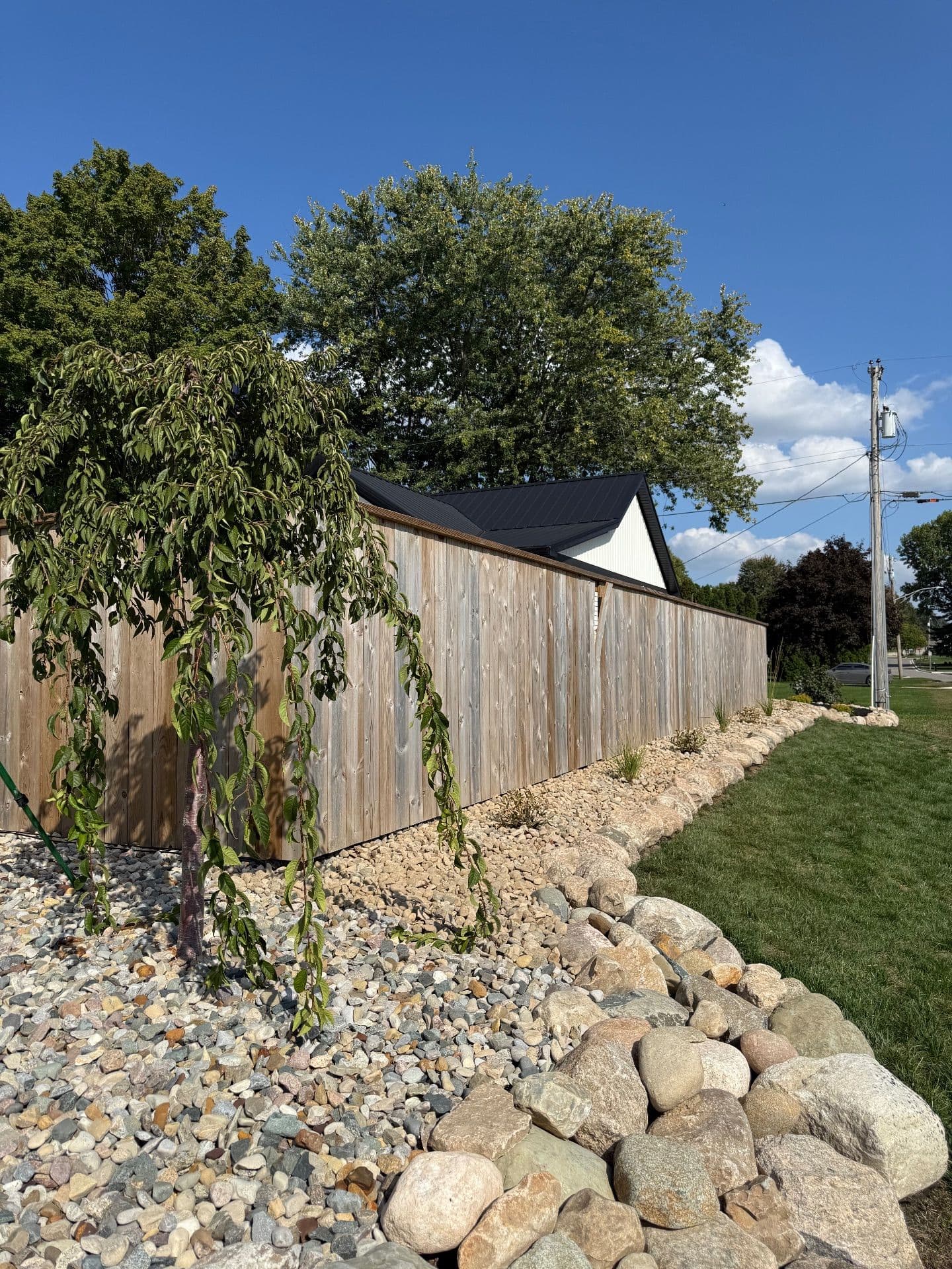 Beautifully Crafted Tiered Boulder Wall with Lush Plantings